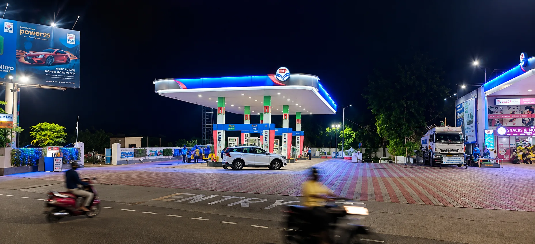 A glowing HPCL canopy picture taken from slight right from the front side at night.